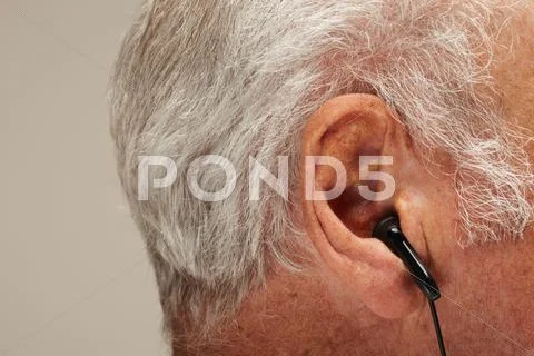 Senior Man Wearing Earphones, Close Up