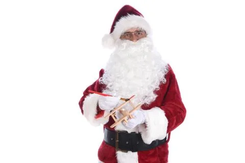 Senior man wearing a traditional Santa Claus costume painting a toy wooden ai Stock Photos