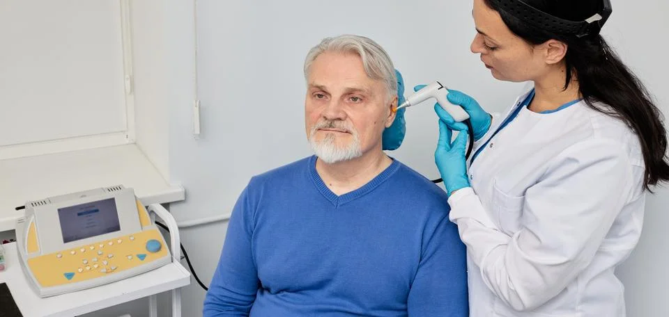 Senior man while tympanometry or impedance audiometry and test of middle-ear  Fotos Stock