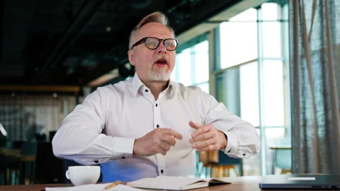 Senior man in white shirt pulls the pages out of his paper book. Stock Footage 273720180