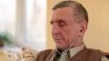 Senior man with white smartphone sits on the couch and listening to music HD Footage