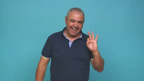 Senior man winks an eye and holds an okay gesture with hand Stock Footage 144217832