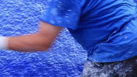Senior man worker painting with hands a wall in blue town Chefchaouen, Morocco Stock Footage 77969129