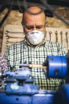 Senior man working in a carpentry Stock Photos