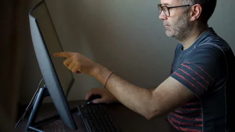Senior man is working in front of computer, businessman is using large monitor Stock Footage 166057120