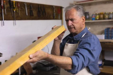 Senior man working in his workshop Photos