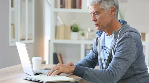 Senior man working from home on laptop computer Stock Footage