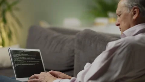Senior man working on laptop computer at home Stock Footage 142340140
