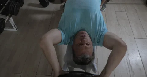 Senior man working out with weight disk Video stock 62911125