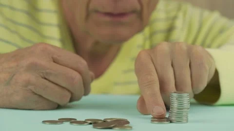 Senior man wrinkled hands stack silver coins on table Video stock 134997809