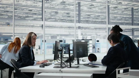 Senior manager analyzing chip architecture with AI model in microchip factory Stock Footage 335880042