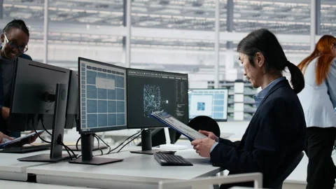 Senior manager analyzing chip architecture with AI model in microchip factory Stock Footage 335881452