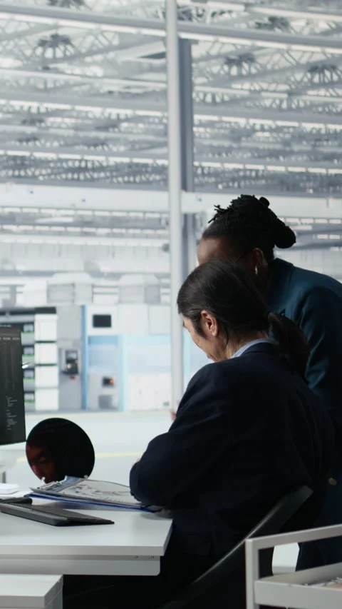 Senior manager analyzing chip architecture with AI model in microchip factory Stock Footage 335883054