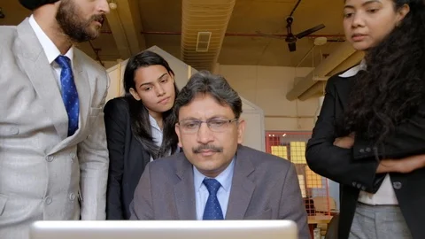 Senior manager is impressed with the work done by juniors and he congratulates t Stock Footage 101936699