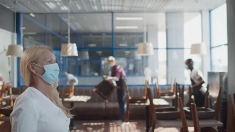 Senior manager of restaurant checking body temperature of staff with thermal Stock Footage 135226878