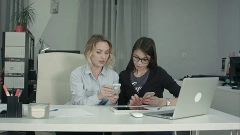 Senior manager showing young intern in glasses how to use mobile app Stock Footage 71130029