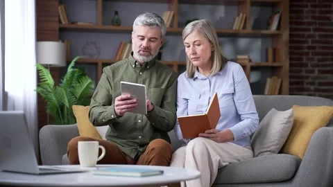 Senior married couple using a financial app on a digital tablet while sitting  Stock Footage 339776268