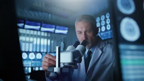 Senior Medical Research Scientist Looking under the Microscope in the Laboratory Stock Footage