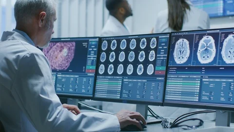 Senior Medical Research Scientist Working with Brain Scans on His PC Stock Footage