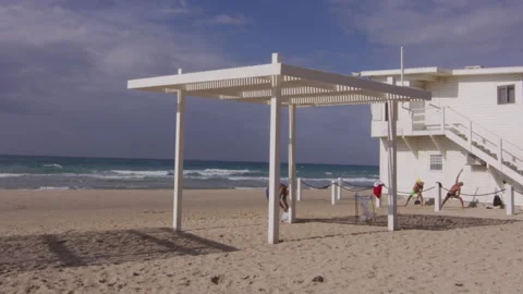 Senior men doing exercises on the beach Stock Footage 229696300