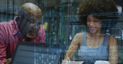 Senior mentor reviewing software code on laptop while mentee taking notes with Stock Footage 308602132