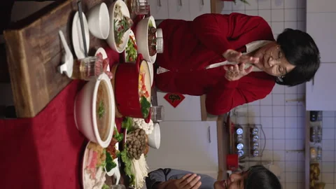 Senior mom putting thumb up while serving Stock Footage 219400620