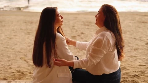 Senior mom touching her daughter's hair, loving mom looking at her beautiful Stock Footage 229476038