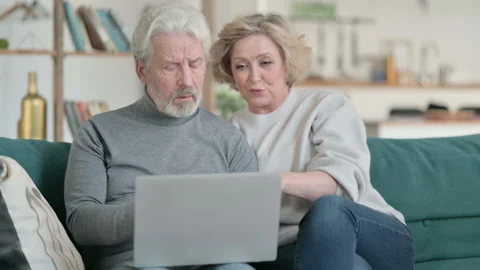 Senior Old Couple Excited while Working on Laptop, Home Video stock 148200982