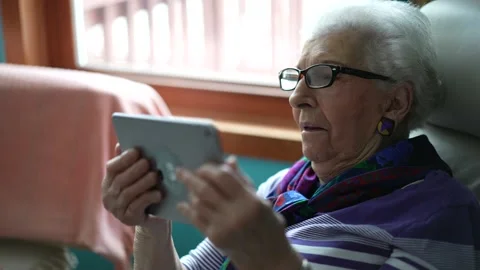 Senior old elderly grey haired woman holding digital tablet video conference Video stock 145851242