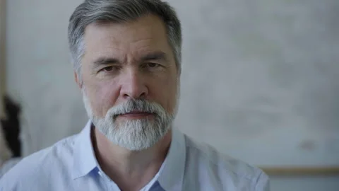 Senior old man looking at camera, mature grandfather posing for video portrait Video stock 252597970