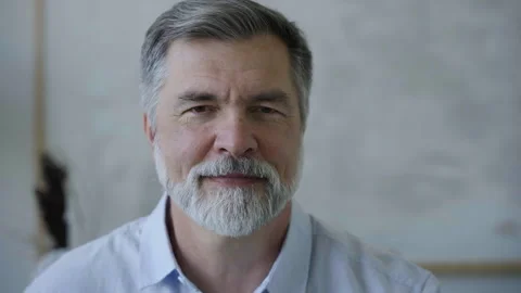 Senior old man looking at camera, mature grandfather posing for video portrait Video stock 252599775