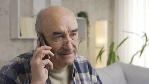 Senior old man talking on the phone is getting angry and grumpy. Video stock 225622993