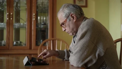 Senior Old Men Sitting at a Table and Using a Tablet Computer Stock Footage 164690054