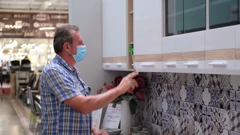 Senior opens the cupboards in the kitchen unit. Shopping precautions Stock Footage 160311265
