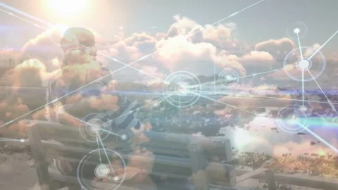 Senior pair sitting bench facing sea as node web appearing, spreading over scene Stock Footage 333609744