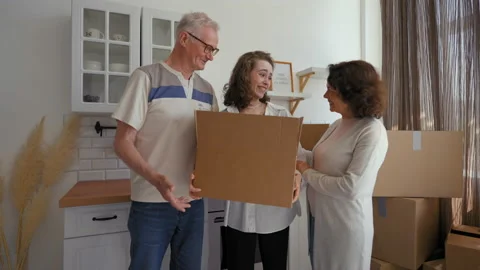 Senior parents help daughter with relocation to apartment Stock Footage 201168936