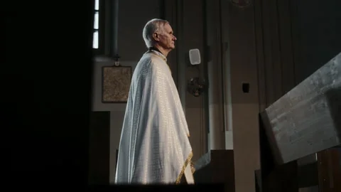Senior Pastor Walking among Empty Pews in Lutheran Church Stock Footage 279826730