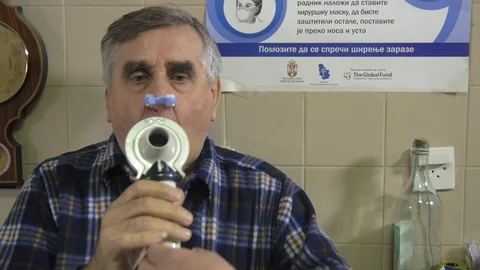 Senior patient using spirometer apparatus on spirometry test in exam room Stock Footage 85700218
