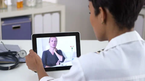 Senior patient video chatting with doctor on ipad Stock Footage