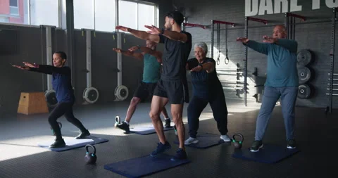 Senior people, coach and exercise in gym with training for strength, balance and Stock Footage 283699573