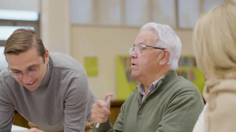 Senior people having class with teacher in library Stock Footage 232621918