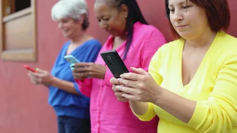 Senior people having fun using mobile phones outdoor Stock Footage 168967333