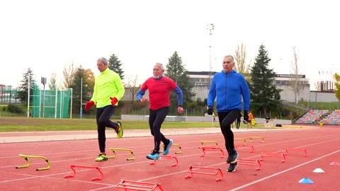 Senior people preparing training elements in a running track Stock Footage 258328712