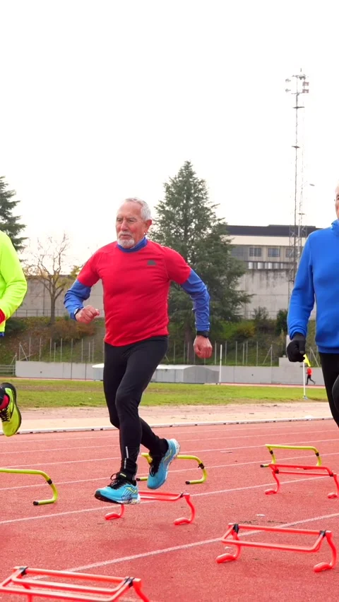 Senior people preparing training elements in a running track Stock Footage 258429101