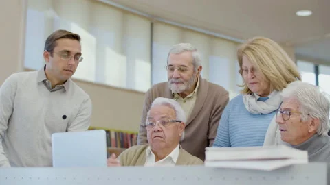 Senior people trying to solve task during class in library Stock-Footage 232623097