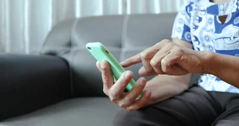 Senior person using a smartphone and tapping the screen. digital technology.. Stock Footage 339018820