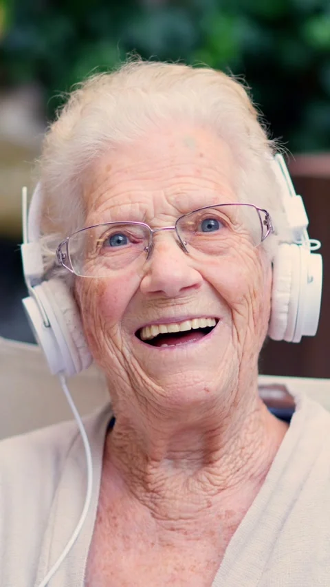 Senior pod-caster waving at camera from a nursing home Stock Footage 255056124