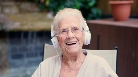 Senior pod-caster waving at camera from a nursing home Stock Footage 256584055