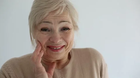 Senior portrait, happy old woman smiling and looking at camera. Slow motion Stock Footage