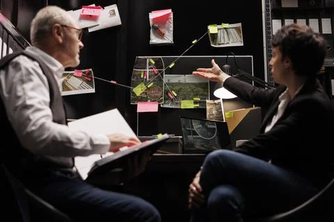 Senior private detective analyzing missing person case, Stockfoto's